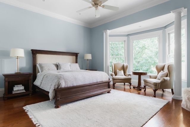 bedroom with ceiling fan, dark hardwood / wood-style flooring, crown molding, and decorative columns