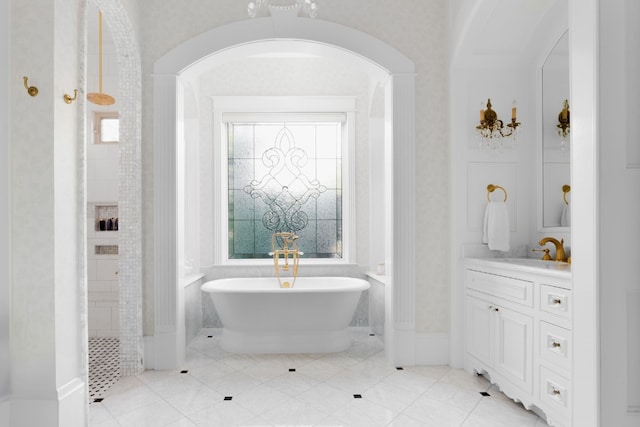 bathroom with a tub and vanity