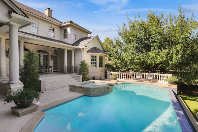 view of pool with an in ground hot tub, ceiling fan, and a patio area