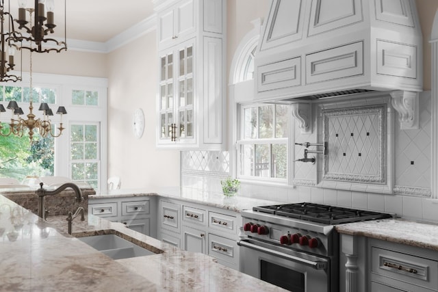 kitchen featuring designer range, decorative backsplash, white cabinets, and light stone countertops