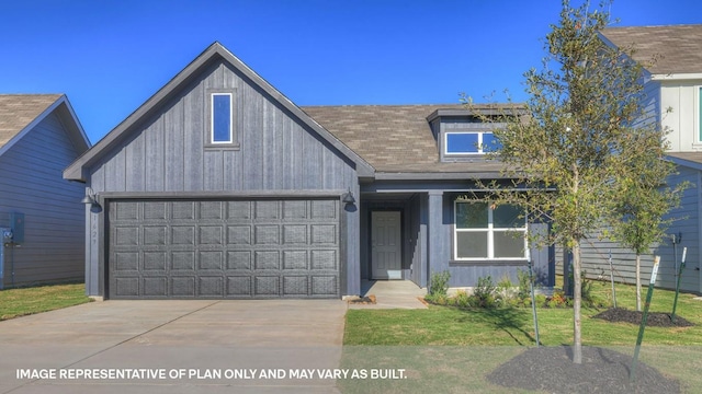 view of front of home featuring a garage and a front yard