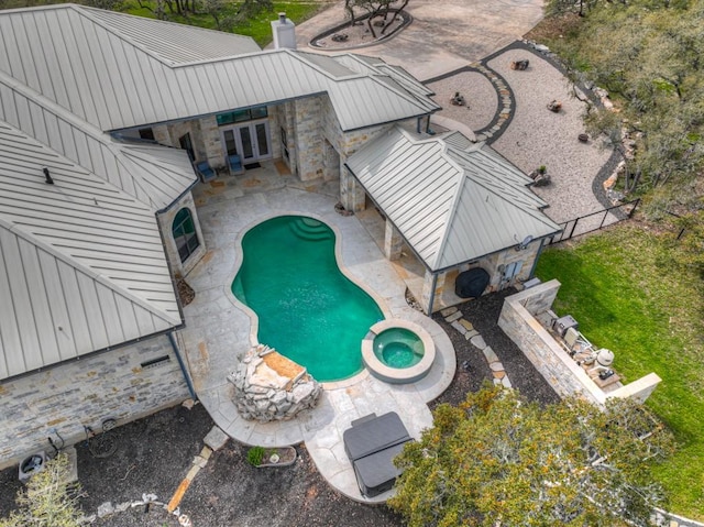 view of swimming pool with an in ground hot tub and a patio