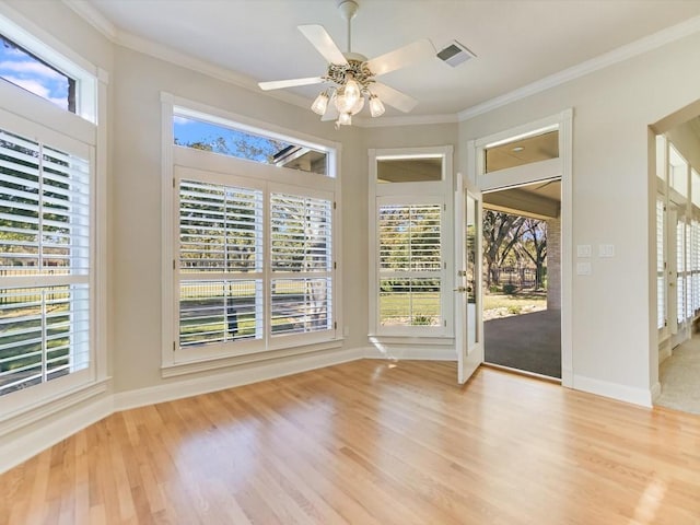 interior space with ceiling fan, ornamental molding, and light hardwood / wood-style flooring