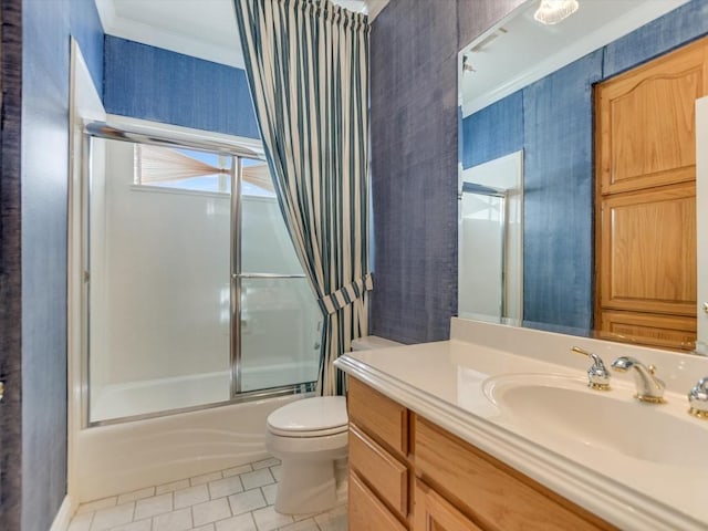 full bathroom featuring combined bath / shower with glass door, vanity, toilet, and ornamental molding