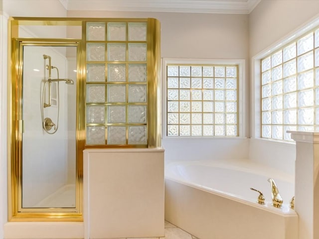 bathroom with plus walk in shower, tile patterned flooring, and ornamental molding