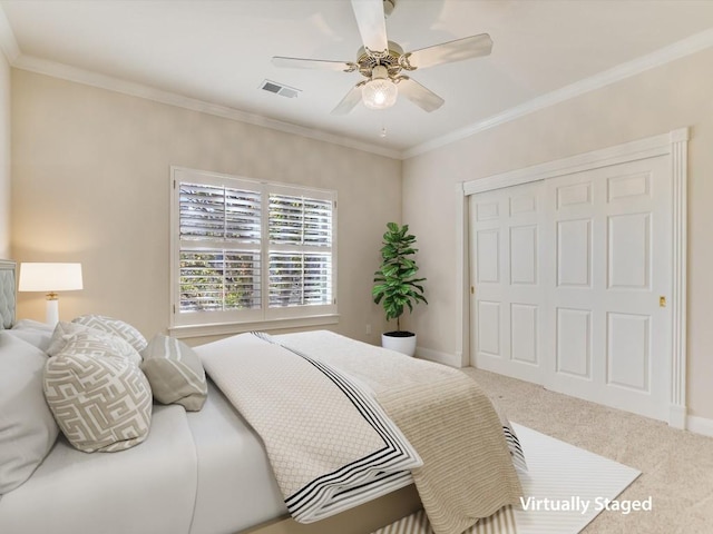 bedroom with ceiling fan, a closet, carpet floors, and ornamental molding