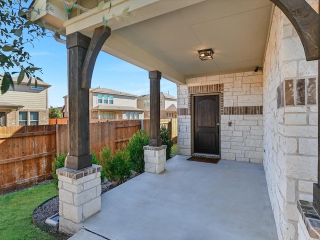 view of exterior entry with a patio area