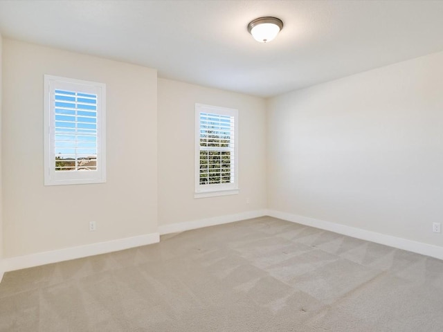 unfurnished room with light colored carpet