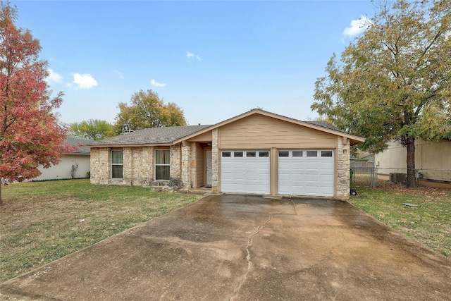 single story home with central AC unit, a front yard, and a garage