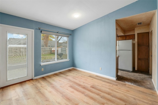 spare room featuring light hardwood / wood-style floors