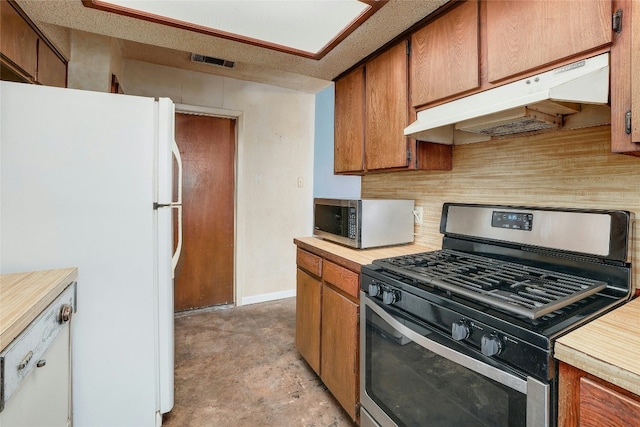 kitchen with a textured ceiling and appliances with stainless steel finishes