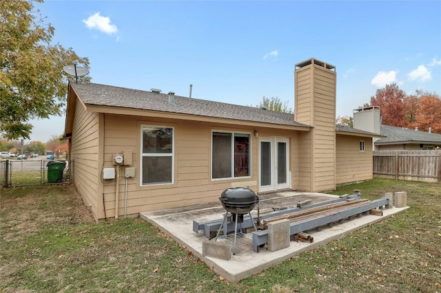 back of house with a yard and a patio