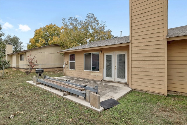 rear view of house featuring a yard and a patio