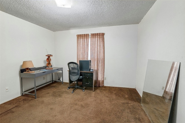 home office featuring carpet flooring and a textured ceiling