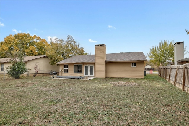 back of house featuring a lawn and a patio