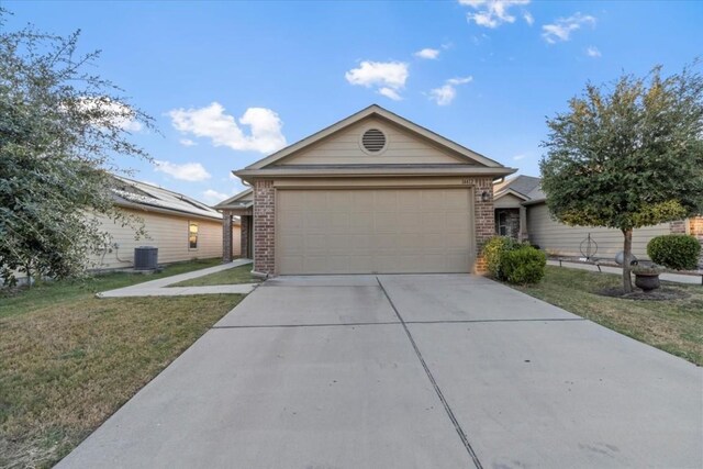 14412 Callan Ct, Manor, TX 78653 - ranch-style home featuring concrete driveway, a front yard, an attached garage, and brick siding
