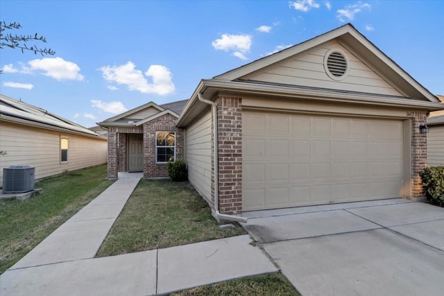 ranch-style house featuring central AC unit, a garage, and a front lawn