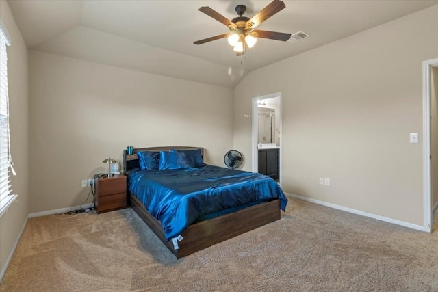 carpeted bedroom with ceiling fan, ensuite bathroom, and lofted ceiling