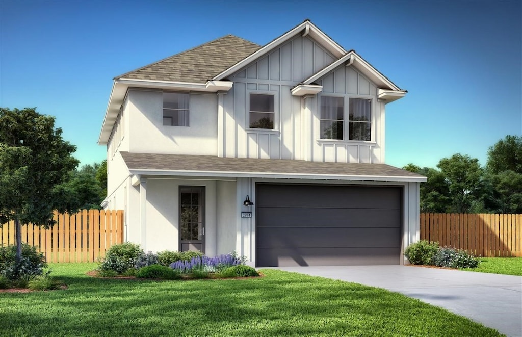 view of front of house with a garage and a front lawn