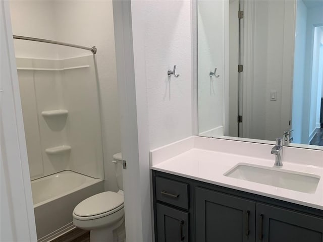 bathroom featuring vanity, shower / bathing tub combination, and toilet