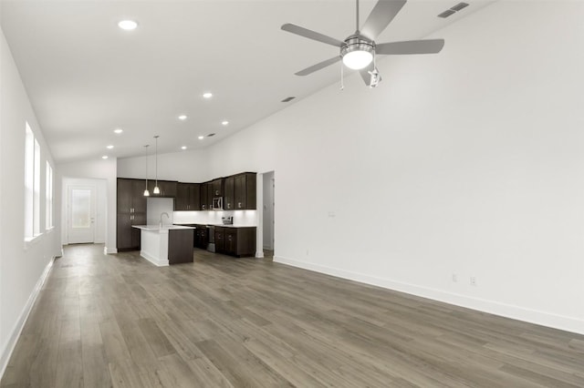 1117 Yaupon Holly Dr, Georgetown, TX 78628 - unfurnished living room with recessed lighting, visible vents, a sink, and wood finished floors