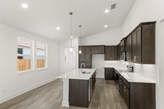 1117 Yaupon Holly Dr, Georgetown, TX 78628 - kitchen with a sink, stainless steel appliances, dark brown cabinets, and visible vents