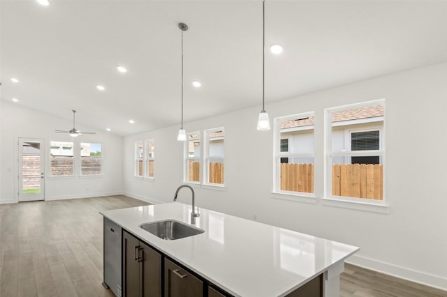 1117 Yaupon Holly Dr, Georgetown, TX 78628 - kitchen featuring baseboards, ceiling fan, a sink, light countertops, and light wood-type flooring