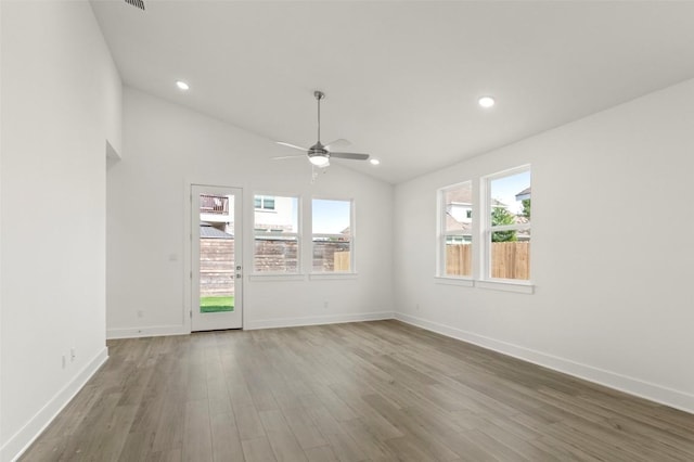 1117 Yaupon Holly Dr, Georgetown, TX 78628 - spare room featuring wood finished floors, a ceiling fan, baseboards, lofted ceiling, and recessed lighting