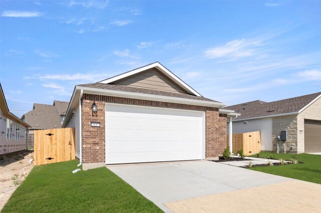 1117 Yaupon Holly Dr, Georgetown, TX 78628 - single story home featuring a gate, fence, a front yard, brick siding, and driveway