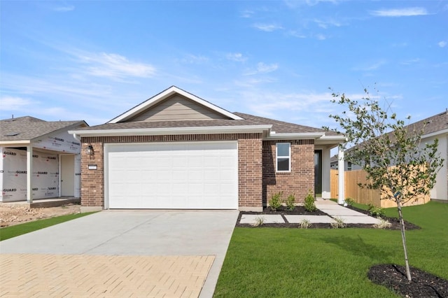 1117 Yaupon Holly Dr, Georgetown, TX 78628 - ranch-style house featuring a garage, a front yard, brick siding, and driveway