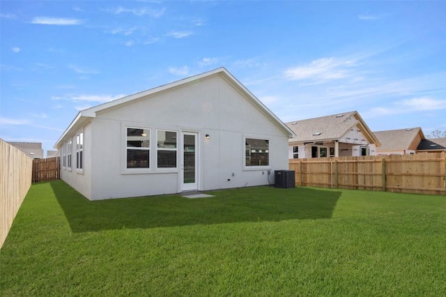 1117 Yaupon Holly Dr, Georgetown, TX 78628 - rear view of house featuring a yard, central AC unit, stucco siding, and a fenced backyard
