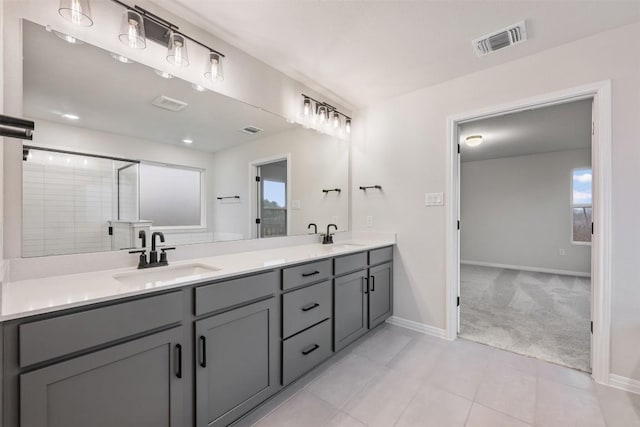 bathroom featuring a shower with shower door and vanity