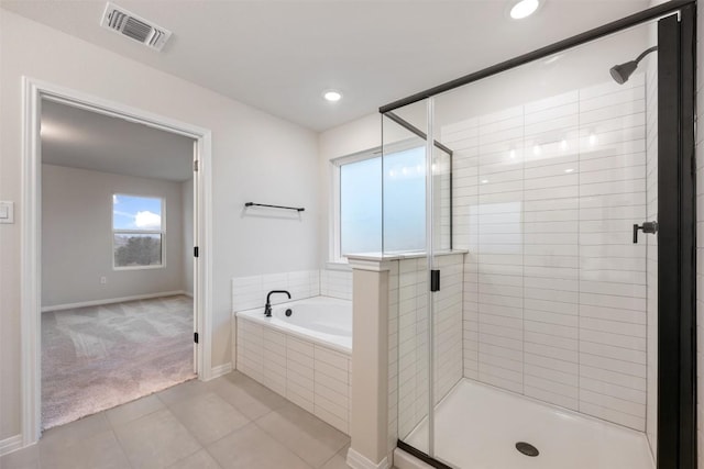 bathroom with separate shower and tub and tile patterned flooring