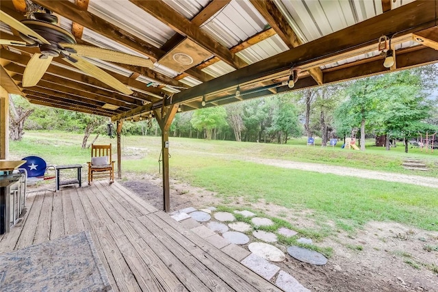 wooden deck featuring ceiling fan and a yard