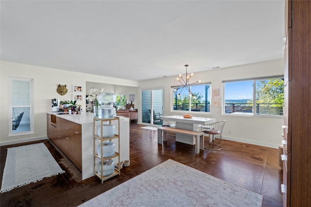 kitchen with pendant lighting, a notable chandelier, and kitchen peninsula