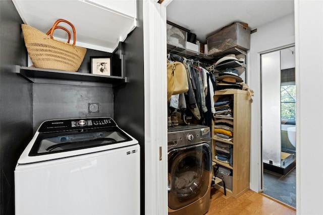 laundry room featuring washer / dryer and light hardwood / wood-style floors