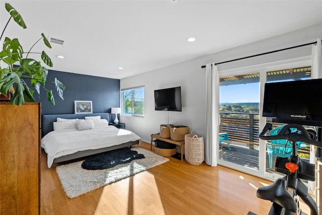 bedroom featuring access to exterior and light wood-type flooring