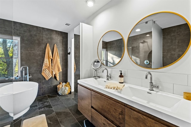 bathroom with tile walls, vanity, and a bathtub