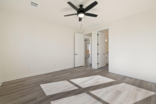 empty room featuring wood-type flooring and ceiling fan