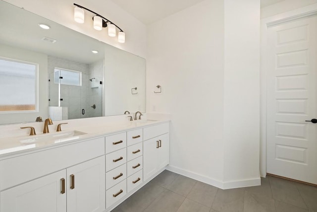 bathroom with tile patterned flooring, vanity, and walk in shower