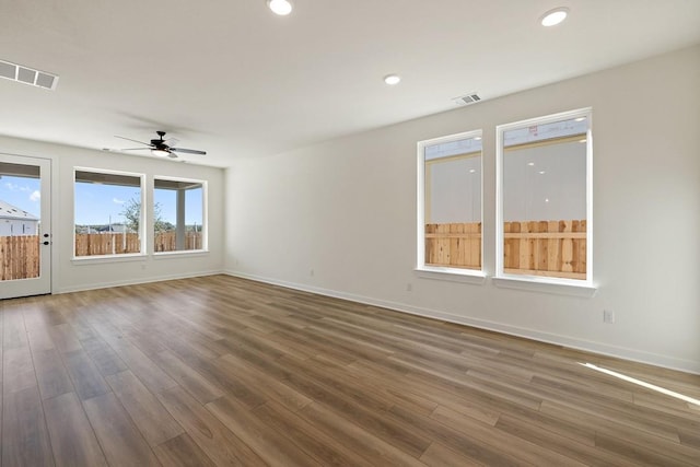 empty room featuring ceiling fan and dark hardwood / wood-style flooring