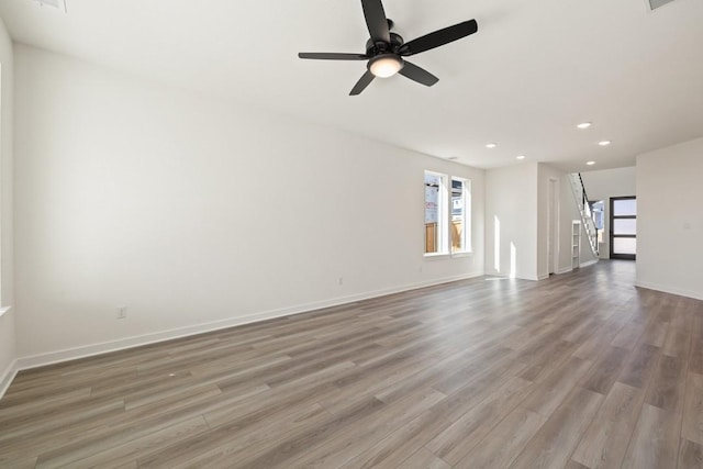 unfurnished living room with hardwood / wood-style floors and ceiling fan