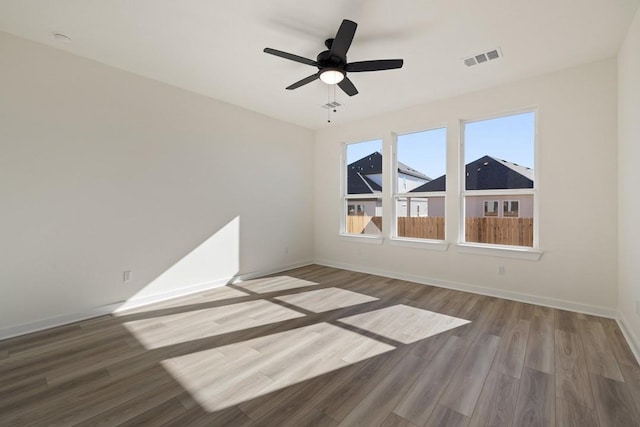 empty room featuring hardwood / wood-style floors and ceiling fan