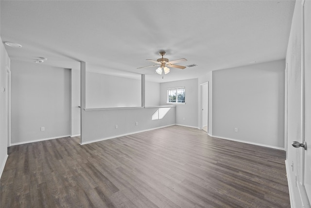 spare room with dark hardwood / wood-style floors and ceiling fan