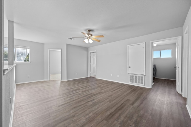 unfurnished living room with ceiling fan and dark wood-type flooring