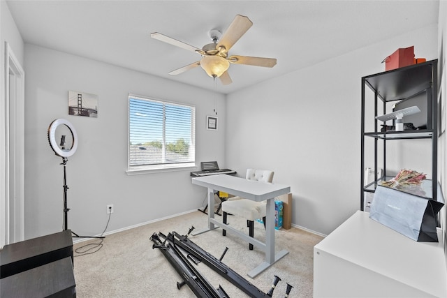 carpeted office featuring ceiling fan