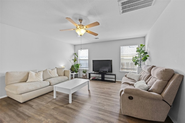 living room featuring hardwood / wood-style floors, plenty of natural light, and ceiling fan