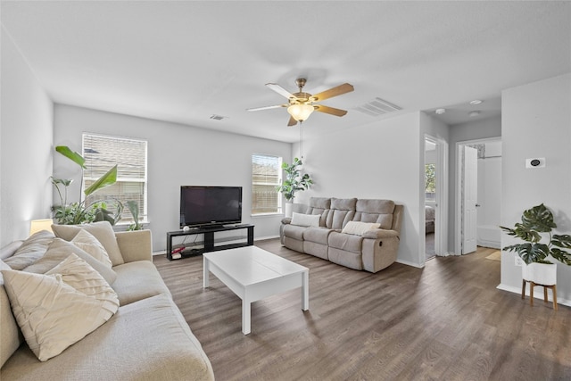 living room with ceiling fan and dark hardwood / wood-style floors