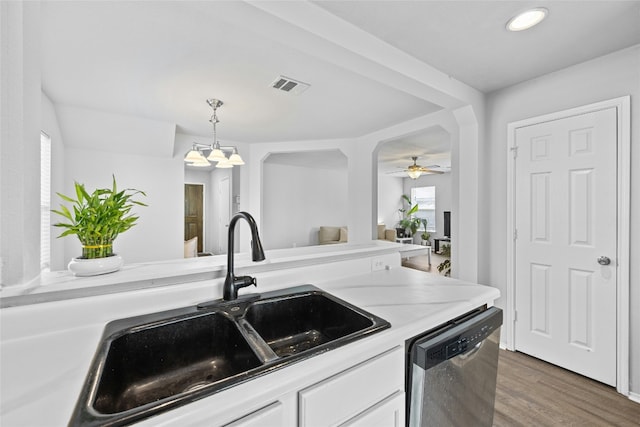 kitchen with dark hardwood / wood-style flooring, white cabinets, sink, dishwasher, and hanging light fixtures