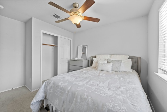 bedroom featuring ceiling fan, a closet, and carpet floors